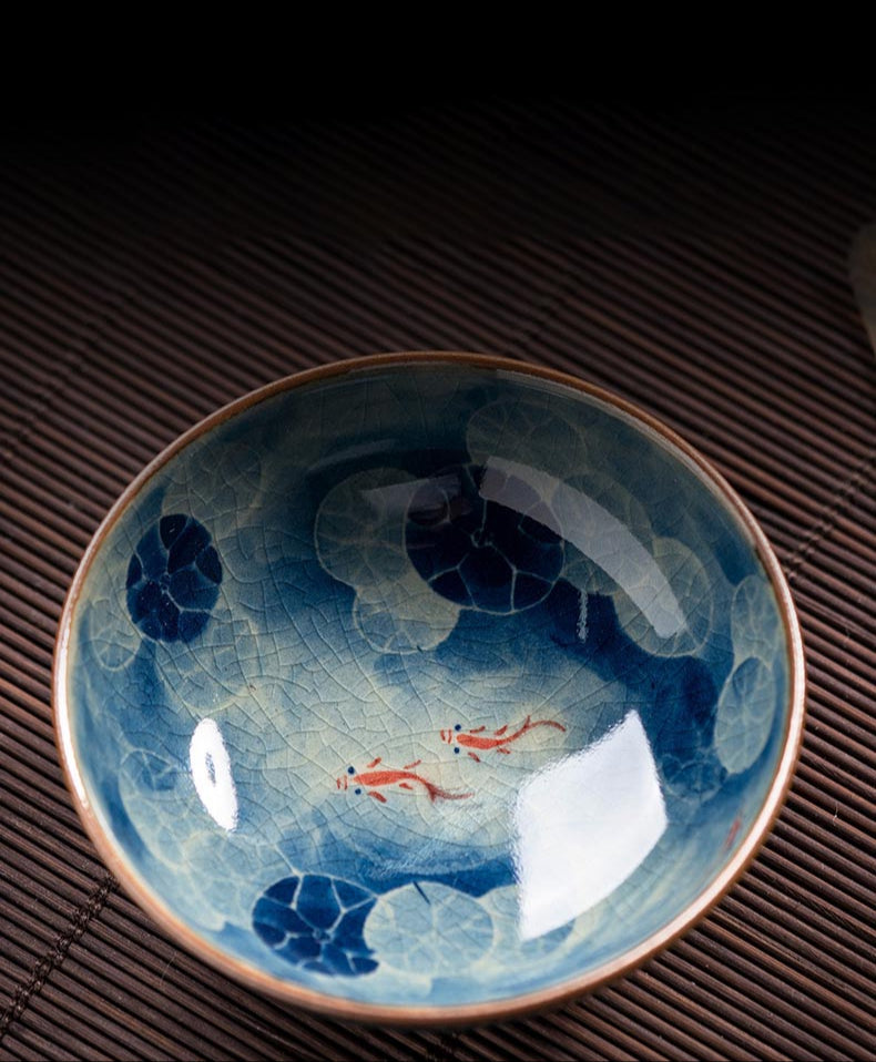 Handcrafted Jian Zhan Jingdezhen Porcelain Tea Cup with Blue & White Lotus Fish Design