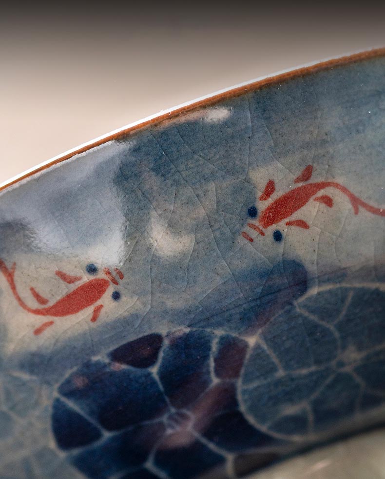 Handcrafted Jian Zhan Jingdezhen Porcelain Tea Cup with Blue & White Lotus Fish Design